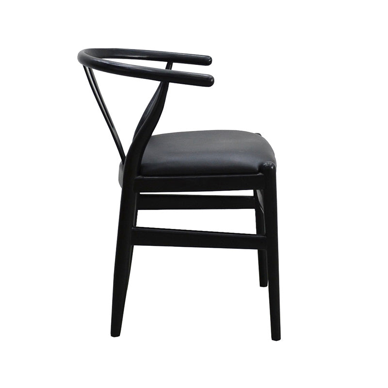 Side profile of the wishbone chair, the back rail curving forward past the seat