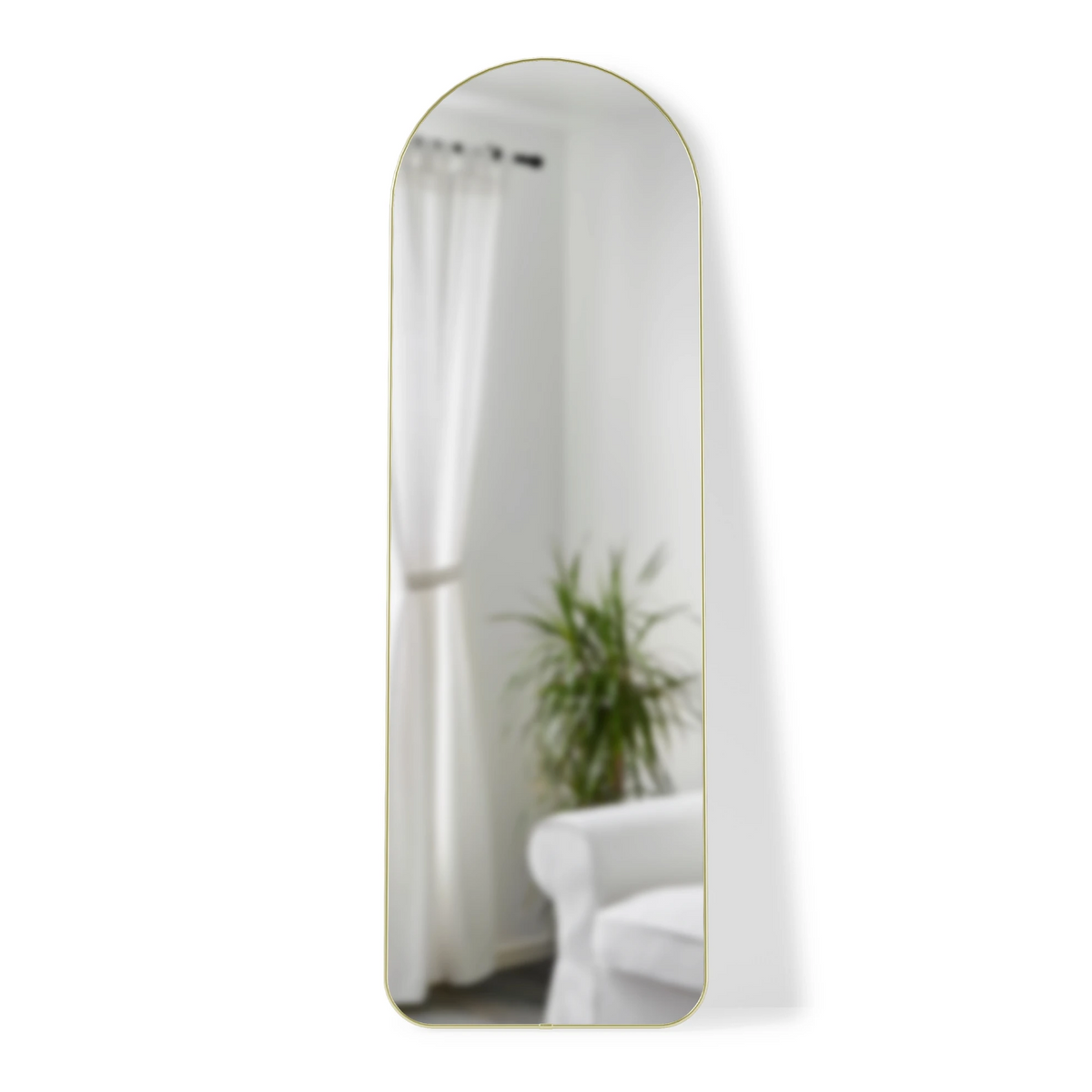 Umbra Hubba arched leaning mirror in brass, 51 x 158cm, leaning in a modern living room
