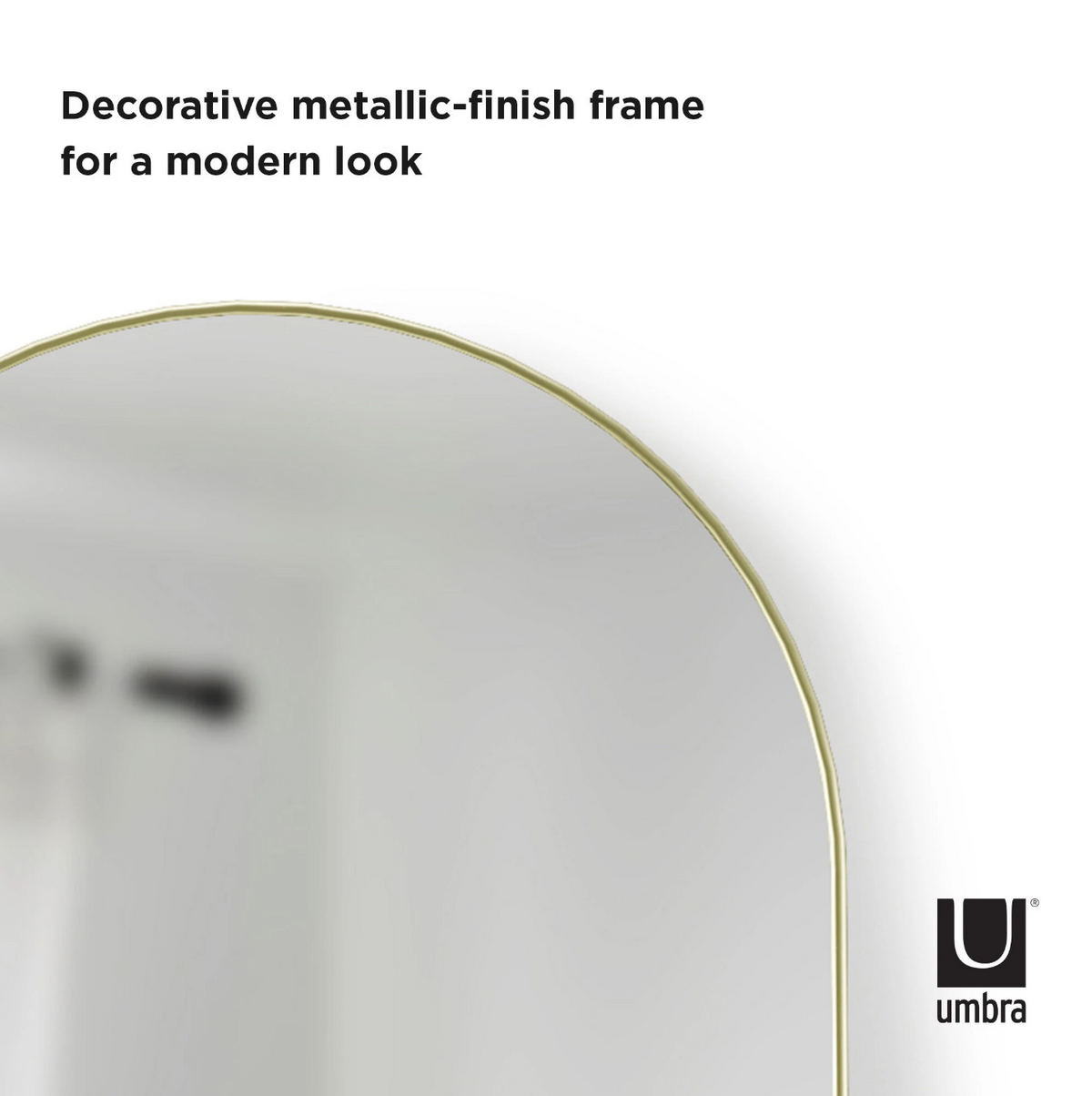 Umbra Hubba arched leaning mirror in brass, detail of the slim metallic rim