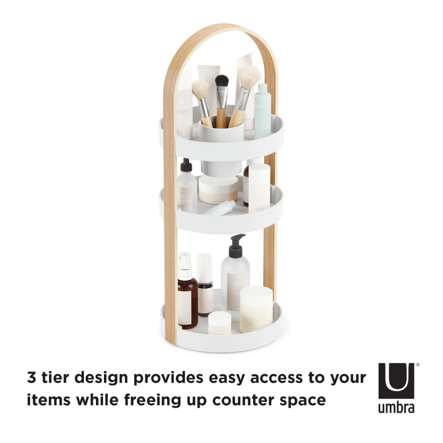 Three-tier white and timber Umbra Bellwood organiser holding skincare, captioned about its tiered design