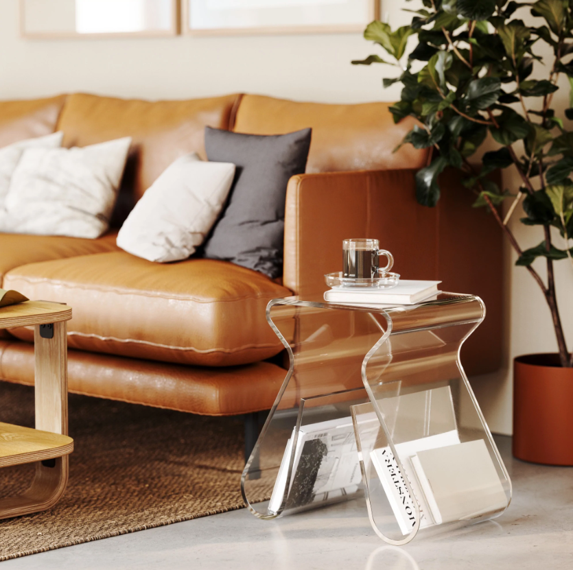 Magino used as a side table beside a tan leather sofa, with magazines in the rack