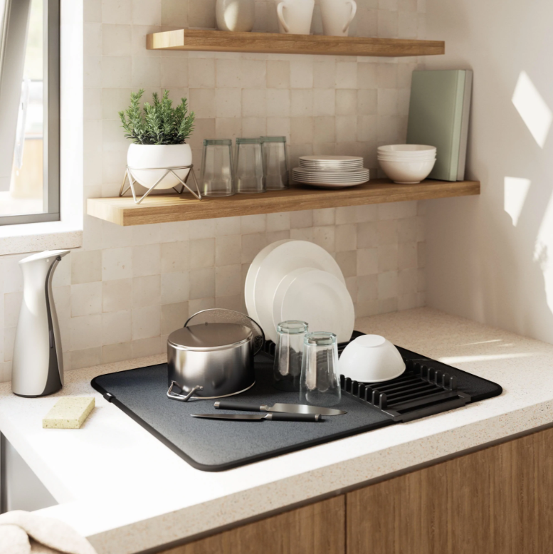 A kitchen with an UDRY DRYING MAT - Black dish rack and utensil caddy on the counter.
