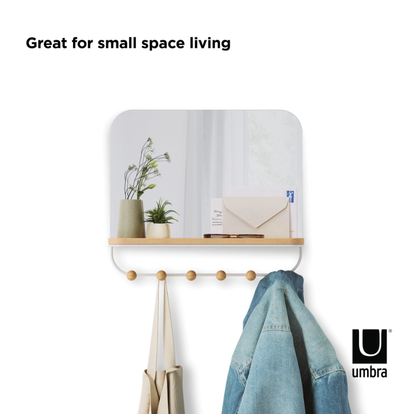 Umbra Estique mirror with shelf and six hooks holding a jacket and a tote bag