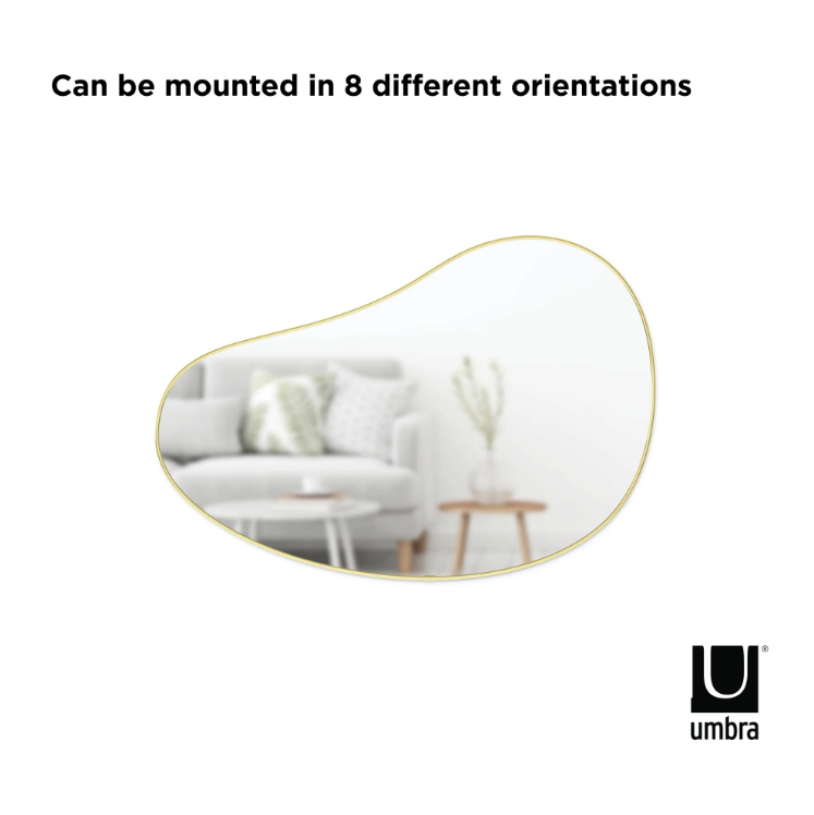 Umbra Hubba Pebble Mirror shown in several of its eight hanging orientations.