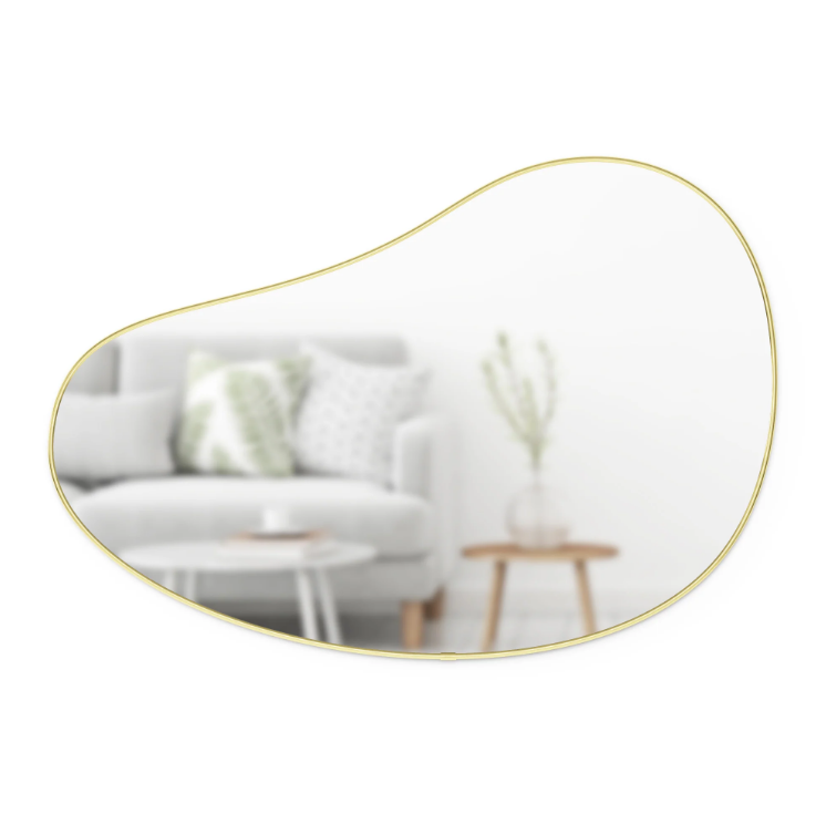 Umbra Hubba Pebble Mirror in brass, an organic pebble-shaped wall mirror with a slim metallic frame.