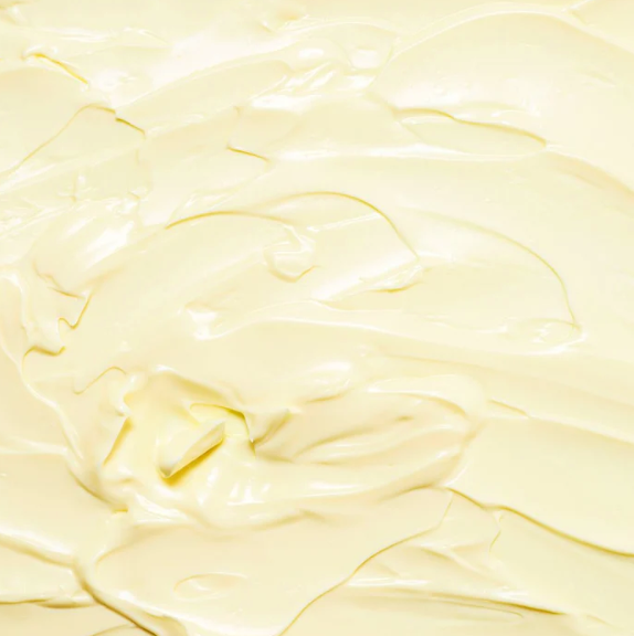 A close up of a yellow AWAKEN BODY CLEANSE whipped cream, infused with aromatherapy oils, by Bonbodi