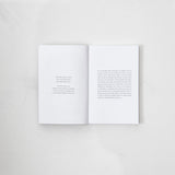 The Strength In Our Scars book by Bianca Sparacino, open on a white surface.