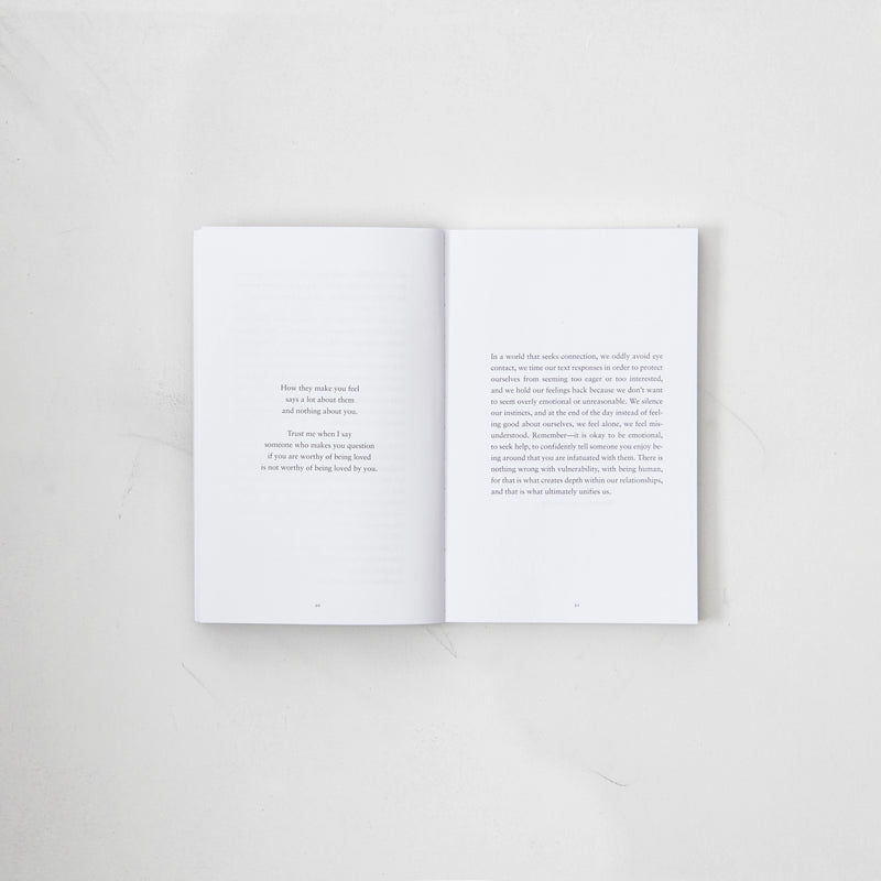 The Strength In Our Scars book by Bianca Sparacino, open on a white surface.