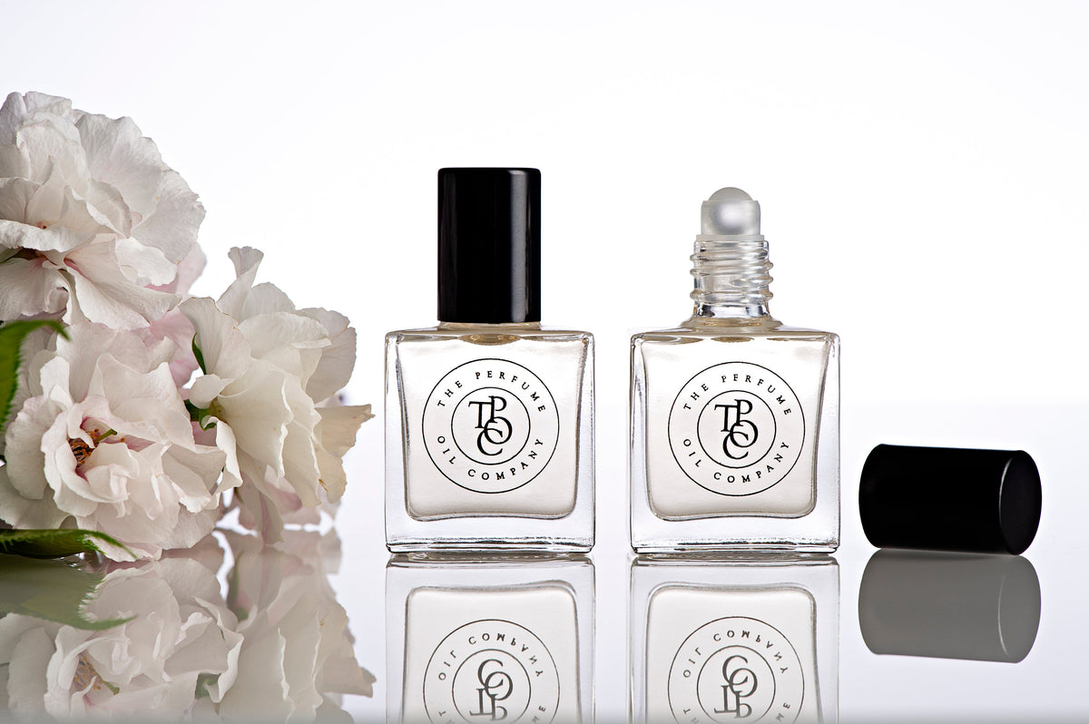 Perfume oil bottles with flowers on a table