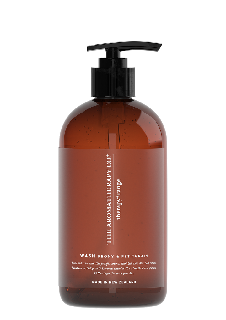 Therapy Soothe Peony & Petitgrain hand and body wash in an amber pump bottle on a white background