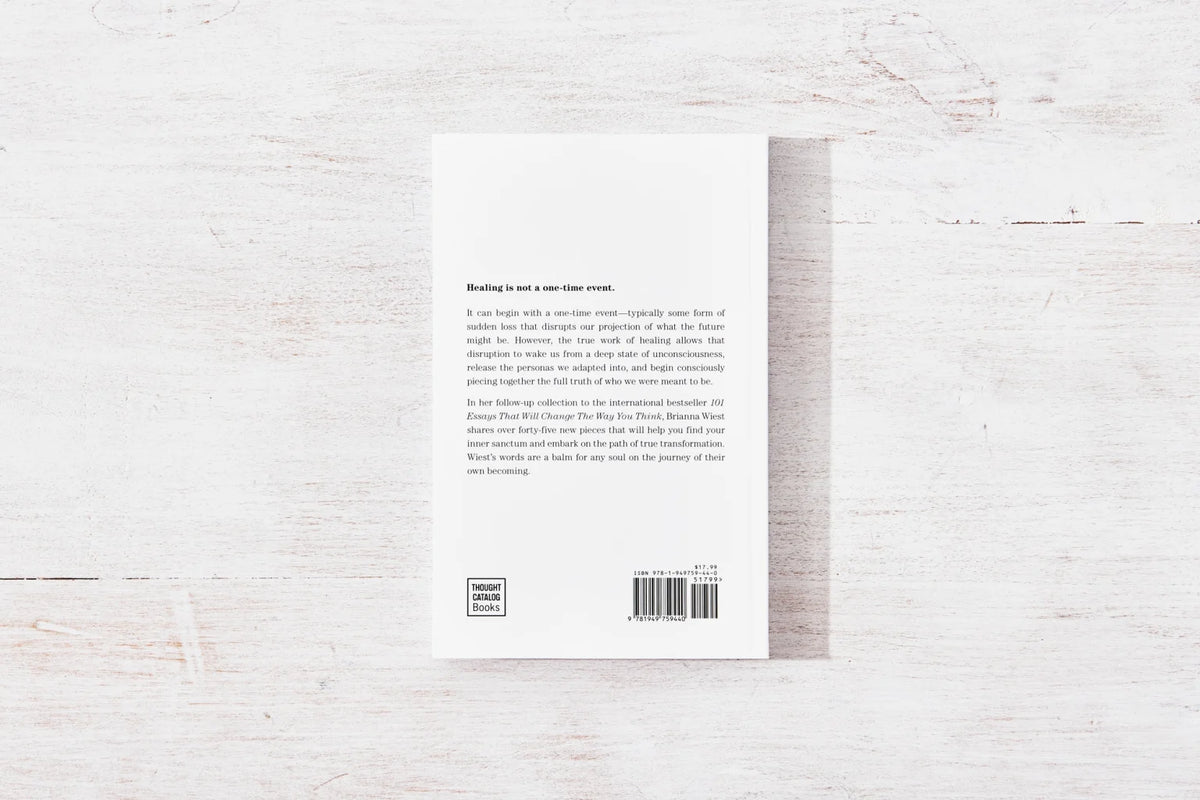 The back of a self-help book on a wooden surface, providing inspiration for healing and personal growth.