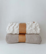 Two Bengali Collections CHUNKY KNIT OATMEAL THROW blankets stacked on top of each other, perfect as lounge throws.