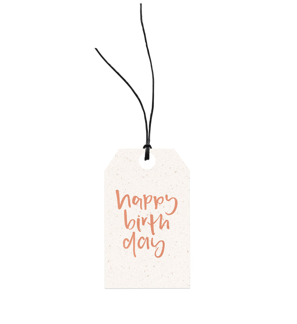 A Emma Kate Co Happy Birthday gift tag on it, attached with hemp twine.