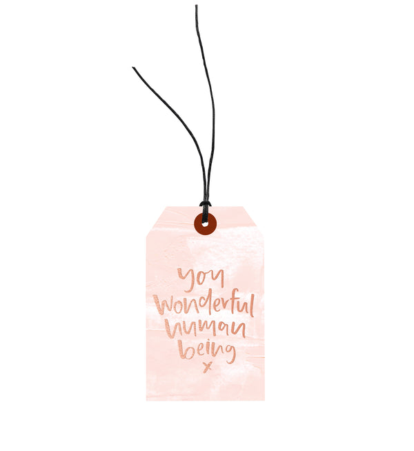 A pink You Wonderful Human Being - Gift Tag by Emma Kate Co, with the words 'your wonderful wonderful woman' on it, attached using European hemp twine for an environmentally responsible touch.