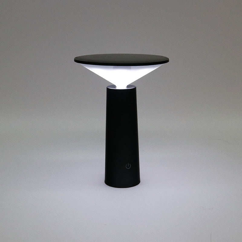 Black LED Tilt lamp lit against a grey backdrop, showing the touch control