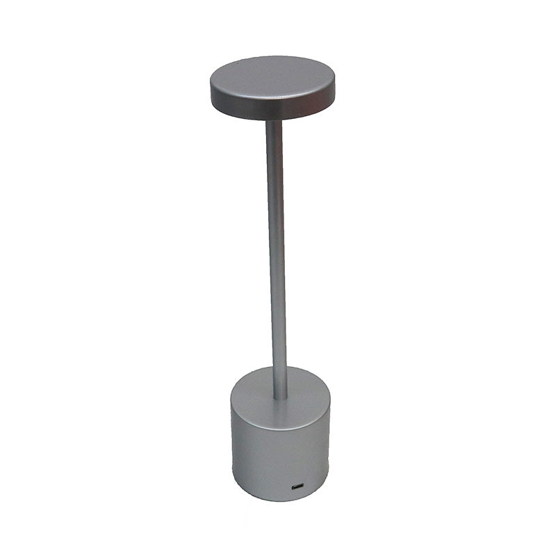 Silver Skyscraper LED lamp at three quarters, showing the weighted cylinder base