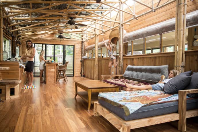 Photo from the book of a timber-lined room with a daybed and polished floor