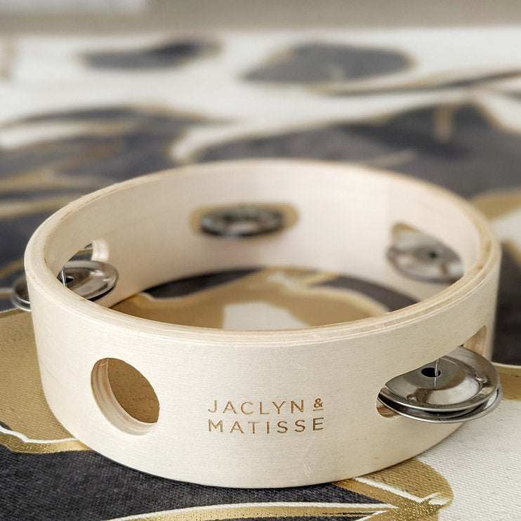 Close view of the white tambourine's jingles and printed name