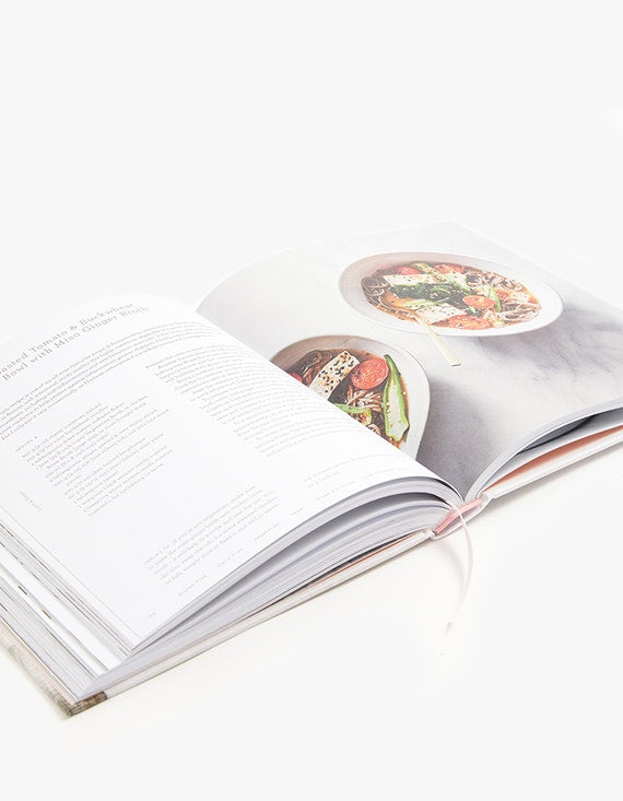 An open book, THE BEAUTY CHEF GUT GUIDE, with a recipe for a dish that promotes gut health.
