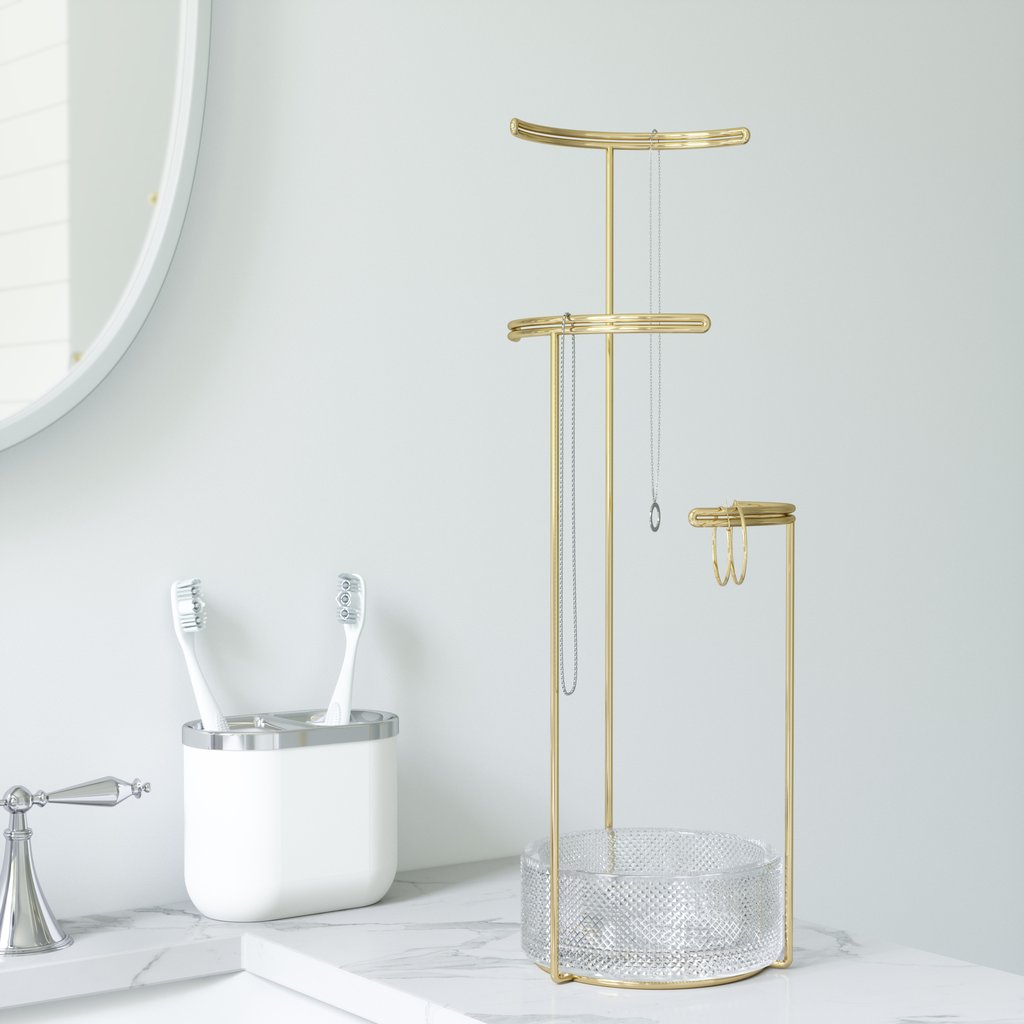 Tesora stand with necklaces and earrings on a marble bathroom vanity