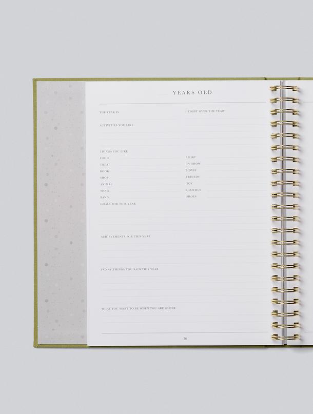 Childhood journal open to a Years Old page with prompts for favourites and milestones