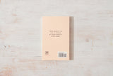A solitary Come Home to Yourself | Déjà Rae notebook resting on a wooden surface by Thought Catalog.