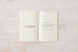 A "Come Home to Yourself | Déjà Rae" design and lifestyle book placed on a wooden surface, by Thought Catalog.