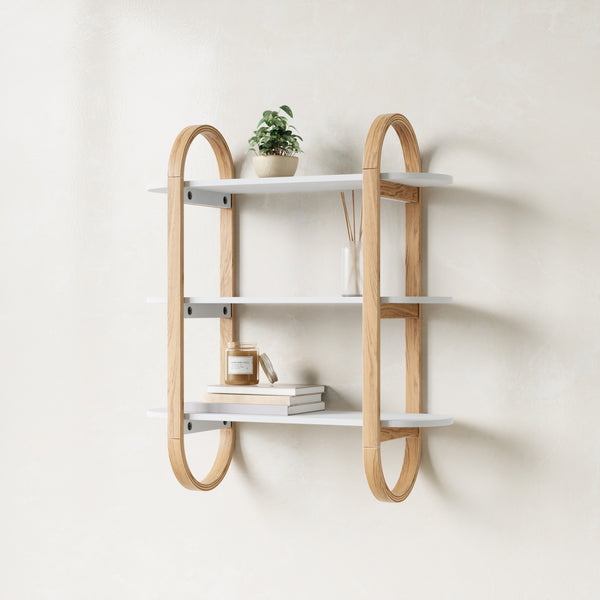 Umbra Bellwood three tier wall shelf in natural with a plant, books and a vase