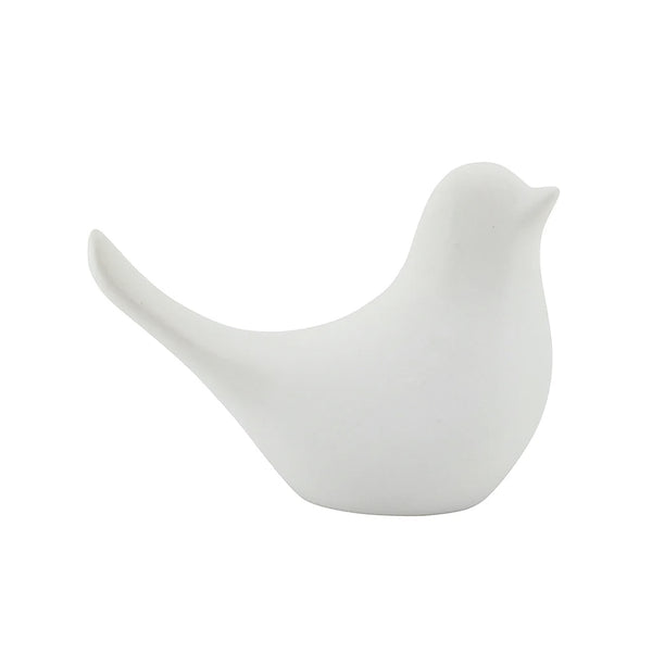 A small white Della Ceramic Dove sitting on a white surface, branded by Flux Home.