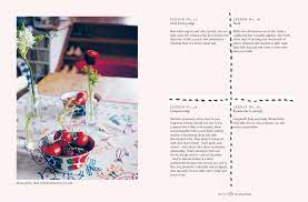 A page from a magazine showcasing a beautiful Home | Victoria Alexander table adorned with vibrant flowers, designed by the Australian Graphic Design Association.