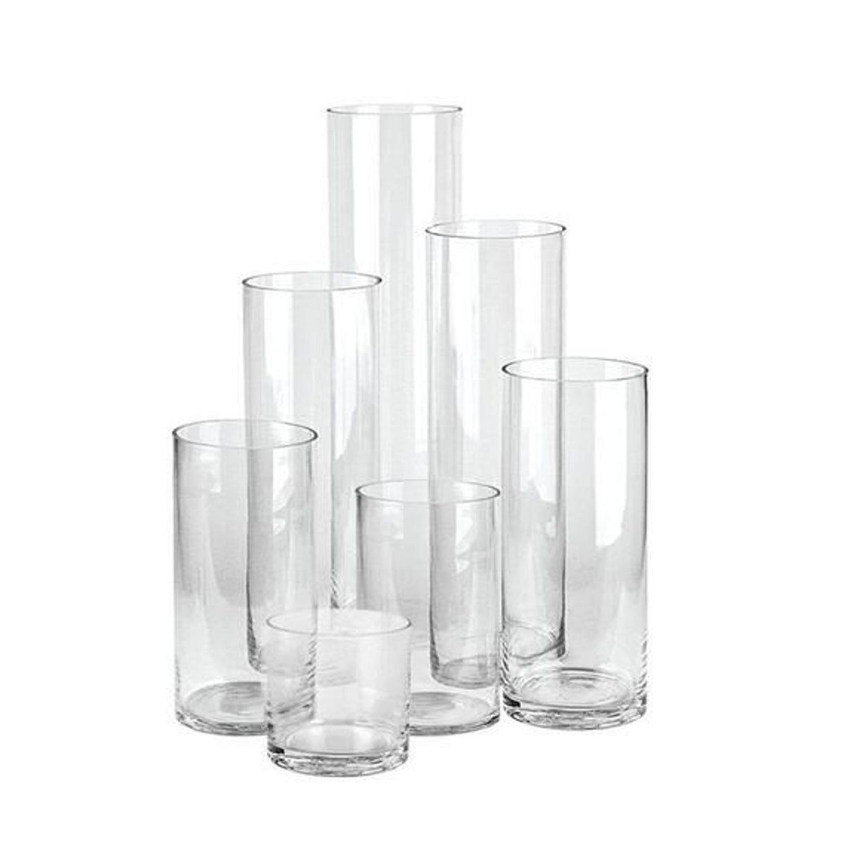 Group of clear glass cylinder vases in graduated heights on white