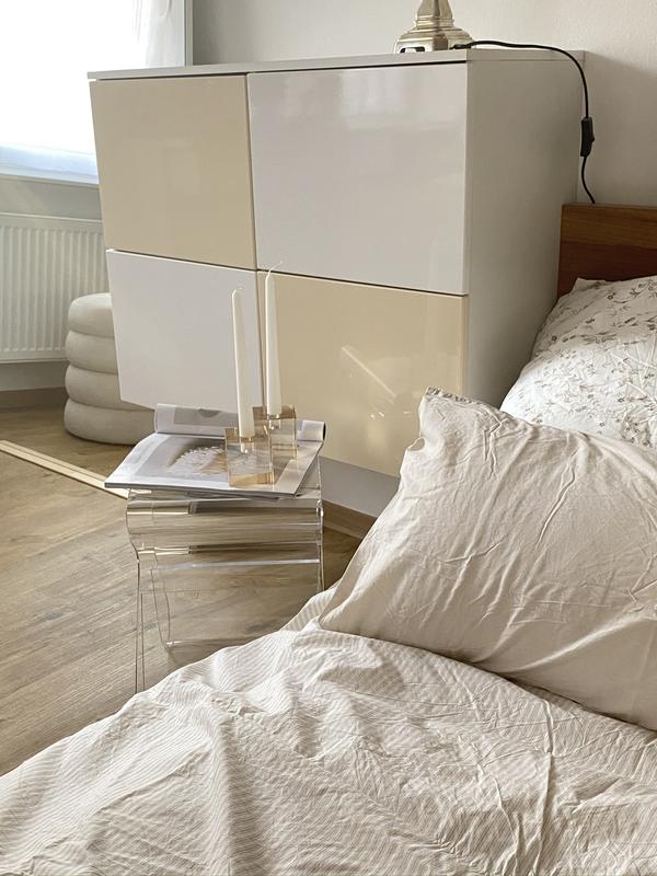 Magino stool as a bedside table beside a linen-made bed and white cabinet