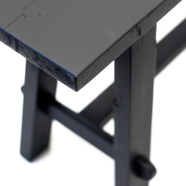 A close up of a repurposed Flux Home TEAK BENCH LONG BLK.