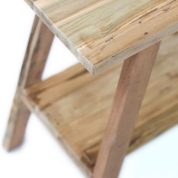 Close up of the console table's teak top edge and shelf, showing grain variation and visible plank joins