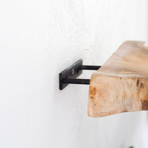 A Flux Home Reclaimed Teak Floating Shelf - Straight hanging on a wall.