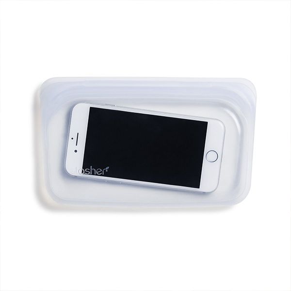 Clear Stasher snack bag holding a white smartphone, on white