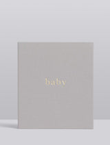 A Write To Me linen-bound BABY | YOUR FIRST FIVE YEARS journal with the word baby on it.