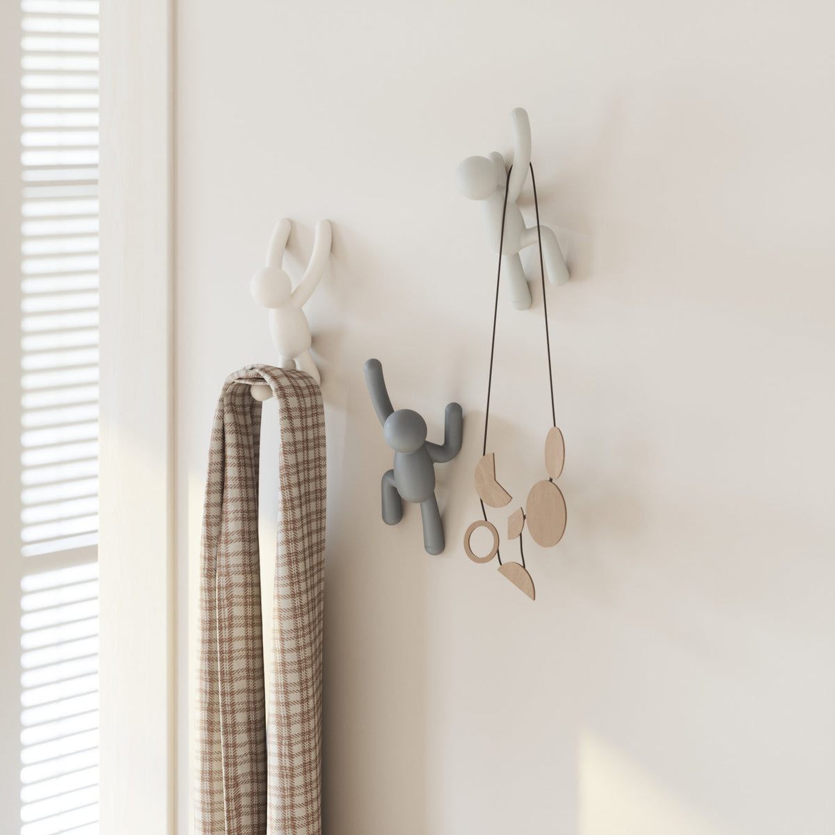 Umbra Buddy Hooks in multi grey on a bathroom wall