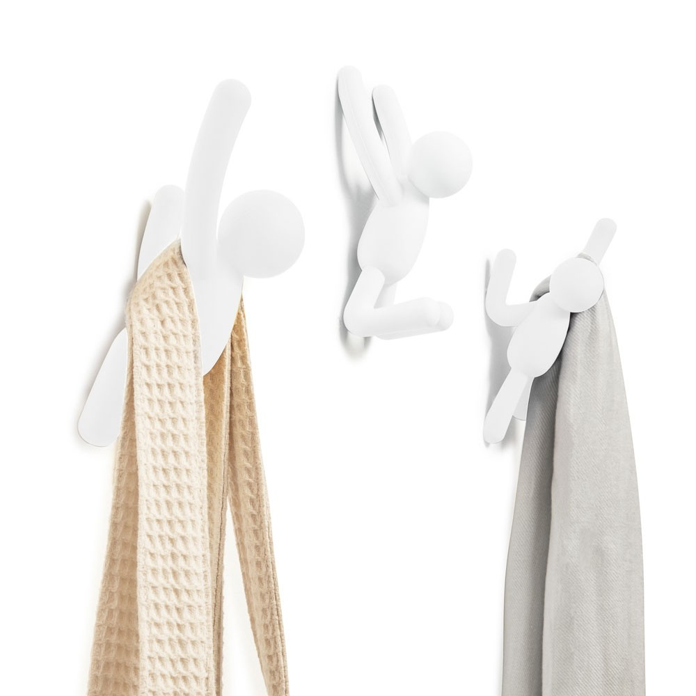 Umbra Buddy hooks in white on a wall holding a waffle towel and a grey scarf