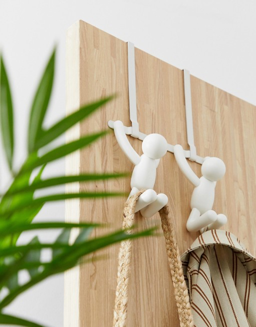 White Umbra Buddy over-the-door hook hanging on a wooden door