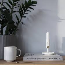 The Interior Design Handbook styled on a coffee table with other books