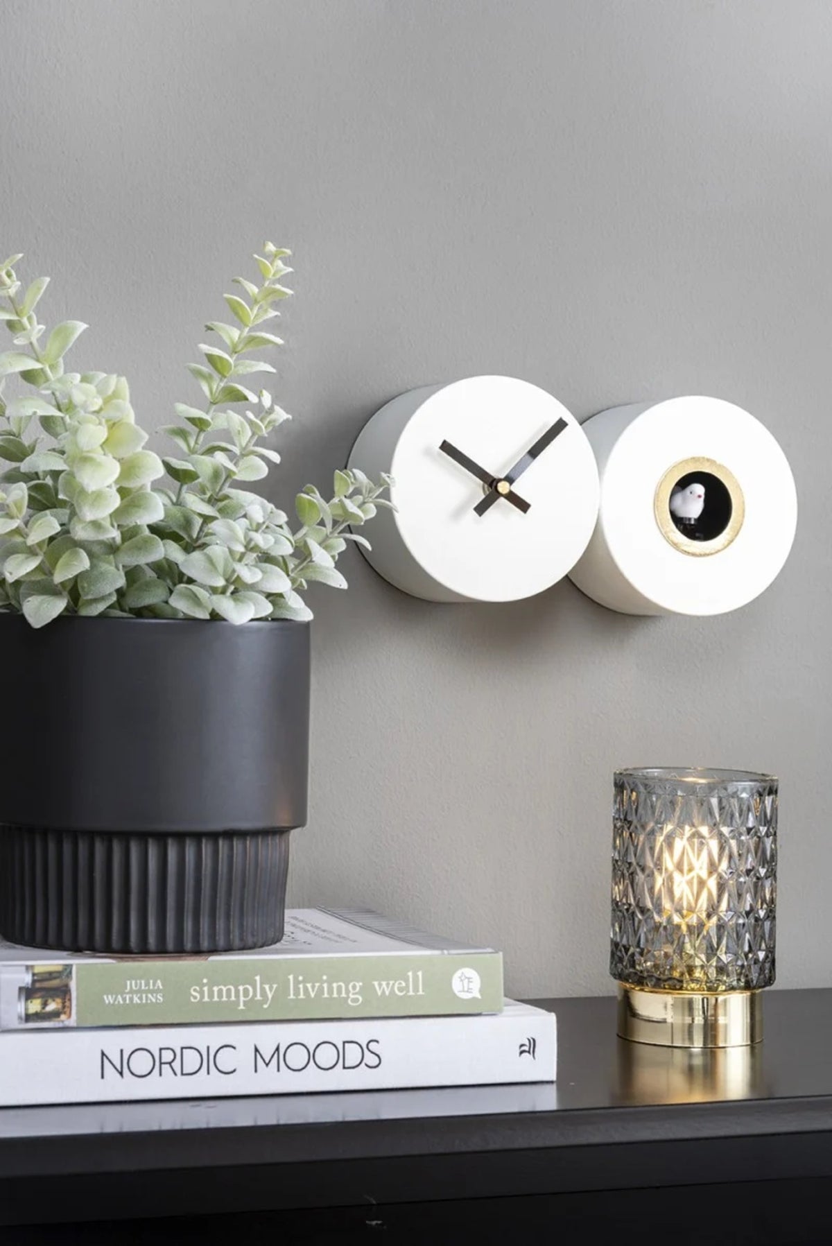 A Karlsson Duo Cuckoo clock on a shelf.