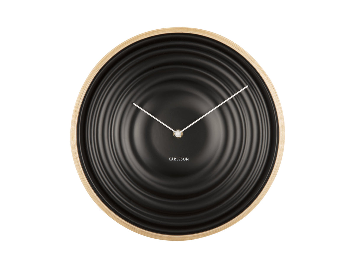 Black Scandi Ribble wall clock with a light timber rim, front view on white