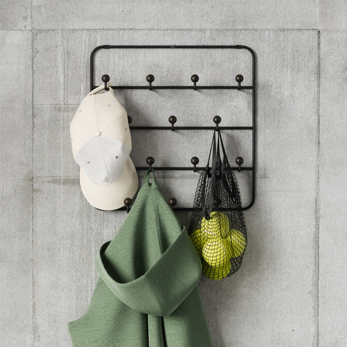 Umbra Estique over the door organizer in a closet holding scarves and accessories