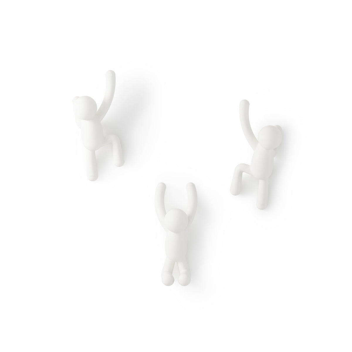 Three Umbra Buddy hooks in white mounted on a plain wall in climbing poses