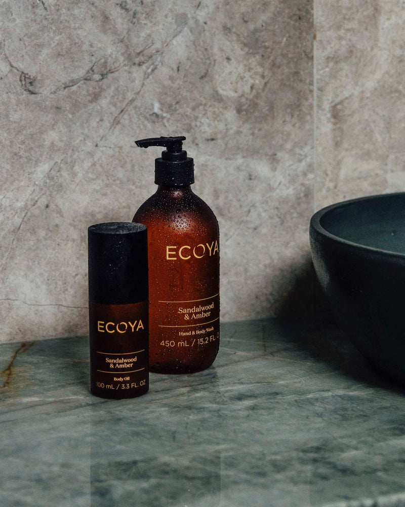Ecoya Limited Edition Scandinavian-inspired Sandalwood & Amber Body Oil displayed on a marble counter, perfect for home fragrance enthusiasts and as thoughtful gifts.