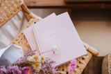 A pink Healthy Nourished Soul - Book sits on top of a wicker chair from Epicurean Publishing.