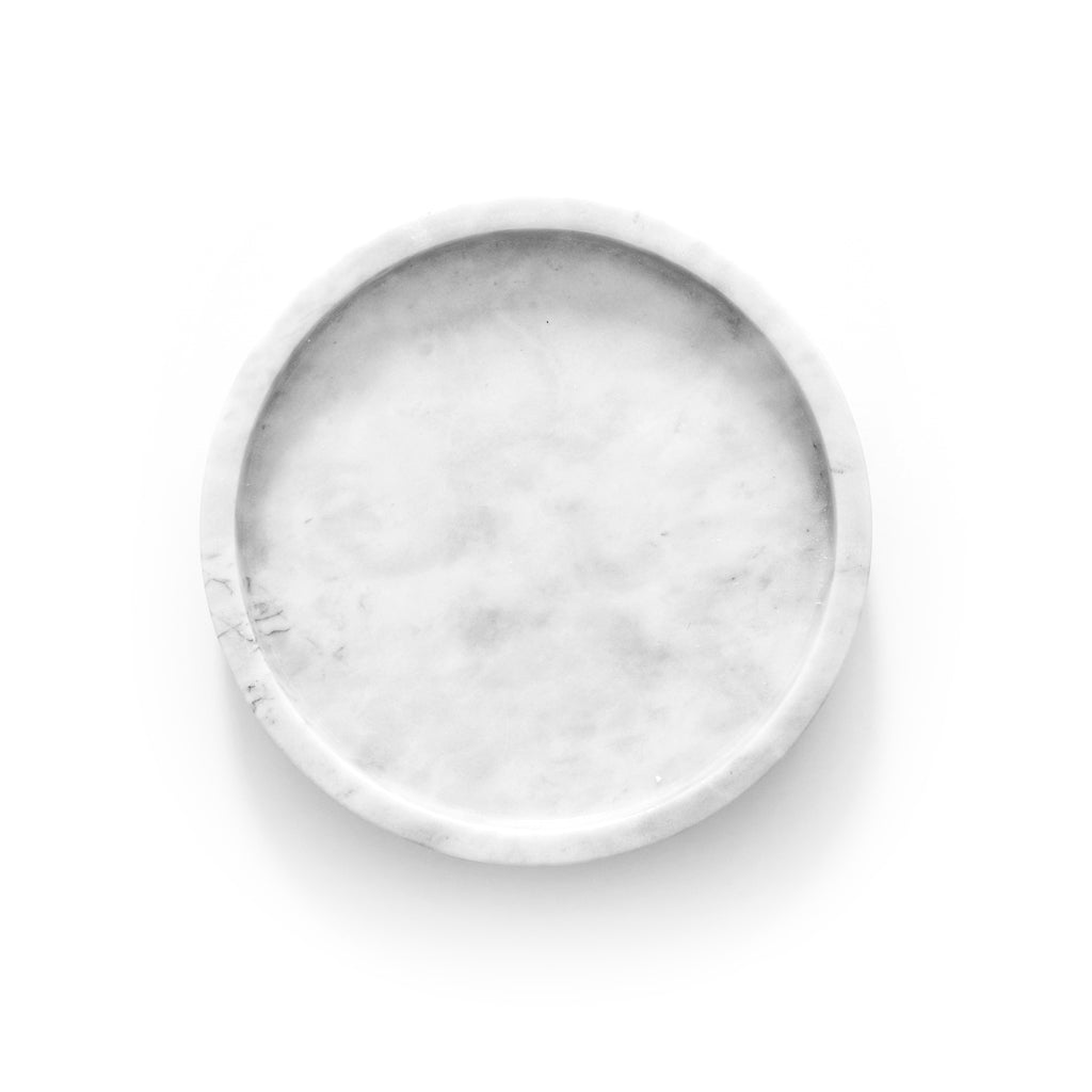 Round grey marble tray styled with notepad and pen on a desk