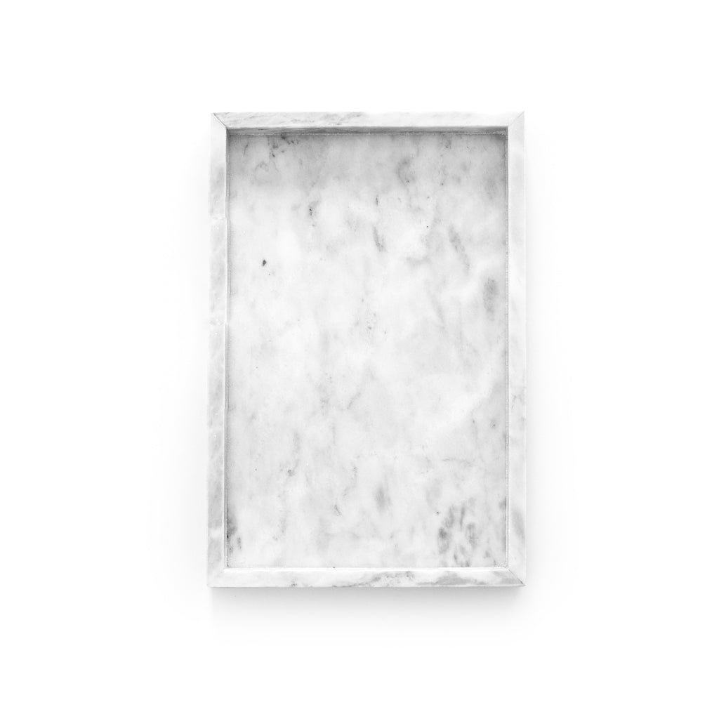 Rectangular grey marble tray styled on a coffee table with books