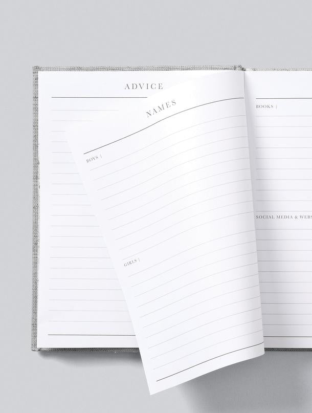 A Write To Me pregnancy journal, 9 Months - The Beginning Of You, is open on a grey surface.